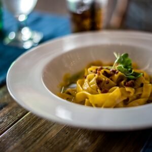 pasta with sauce in white ceramic bowl