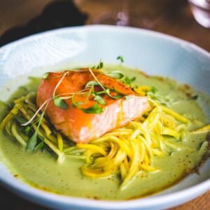pasta with green leaf on white ceramic plate